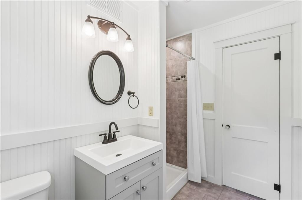 3425 Mercer Road New Castle, PA 16105 - Photo 23 of 38 a bathroom with a sink a toilet and a mirror