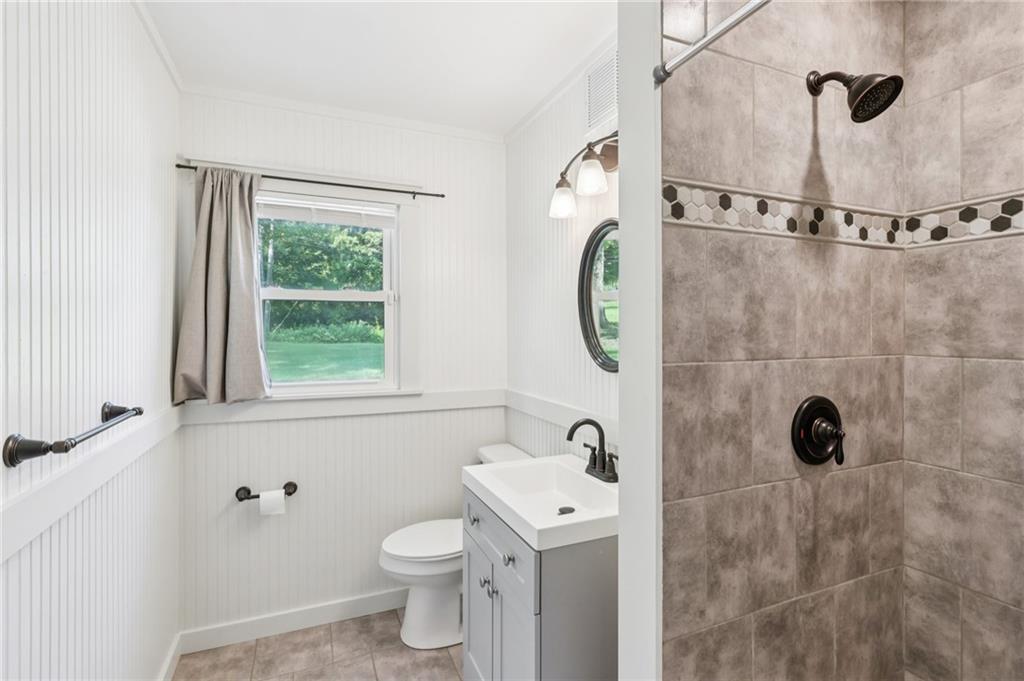 3425 Mercer Road New Castle, PA 16105 - Photo 24 of 38 a bathroom with a shower a toilet and a window