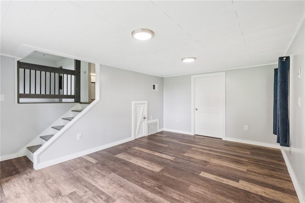3425 Mercer Road New Castle, PA 16105 - Photo 28 of 38 a view of a livingroom with wooden floor and staircase