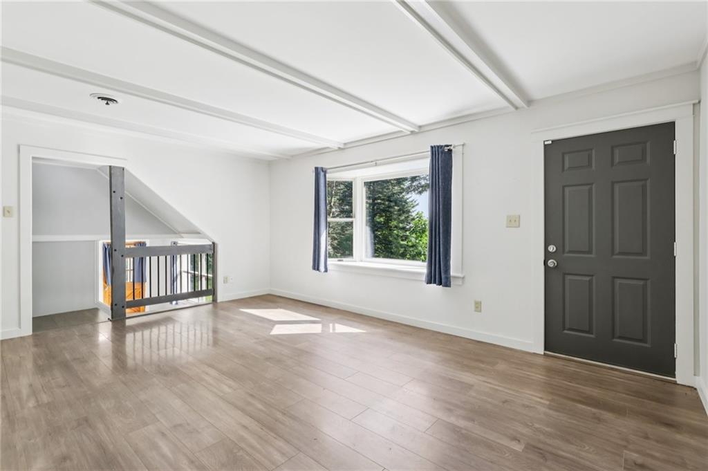 3425 Mercer Road New Castle, PA 16105 - Photo 5 of 38 a view of an empty room with wooden floor and a window