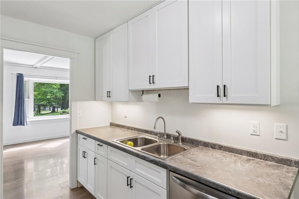 3425 Mercer Road New Castle, PA 16105 - Photo 9 of 38 a kitchen with granite countertop white cabinets and a sink