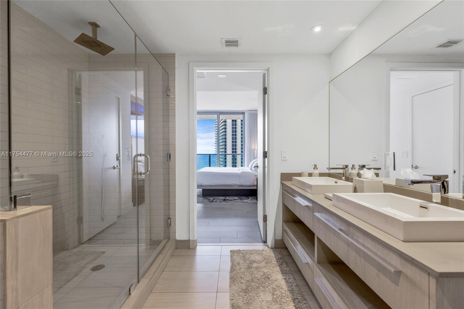 4010 South Ocean Drive, Unit R2505 Hollywood, FL 33019 - Photo 11 of 29 a en suite bathroom with a double vanity sink a mirror and a shower