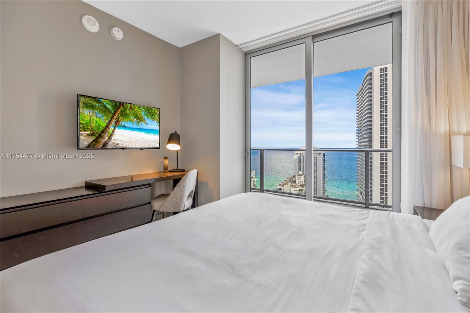 4010 South Ocean Drive, Unit R2505 Hollywood, FL 33019 - Photo 13 of 29 a view of a room with furniture and a flat screen tv