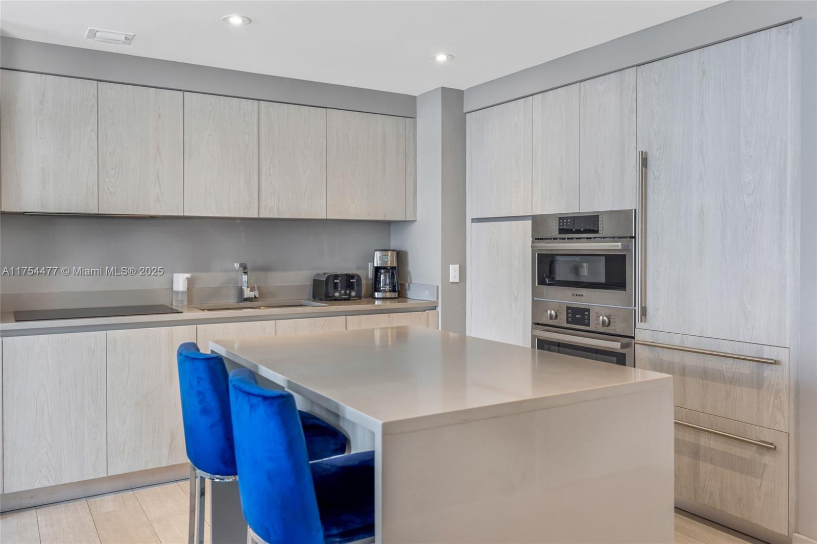 4010 South Ocean Drive, Unit R2505 Hollywood, FL 33019 - Photo 17 of 29 a kitchen with stainless steel appliances a refrigerator sink and cabinets