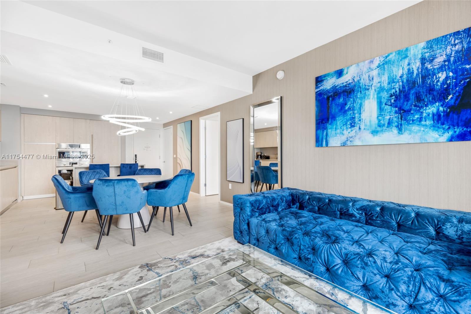 4010 South Ocean Drive, Unit R2505 Hollywood, FL 33019 - Photo 25 of 29 a living room with furniture a dining table and a refrigerator