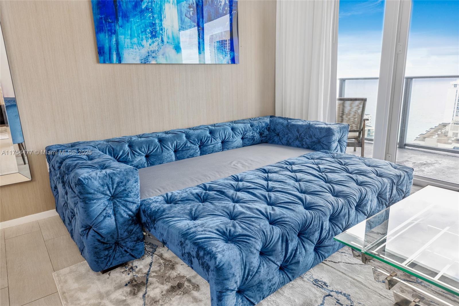 4010 South Ocean Drive, Unit R2505 Hollywood, FL 33019 - Photo 26 of 29 a bed sitting in a bedroom next to a window