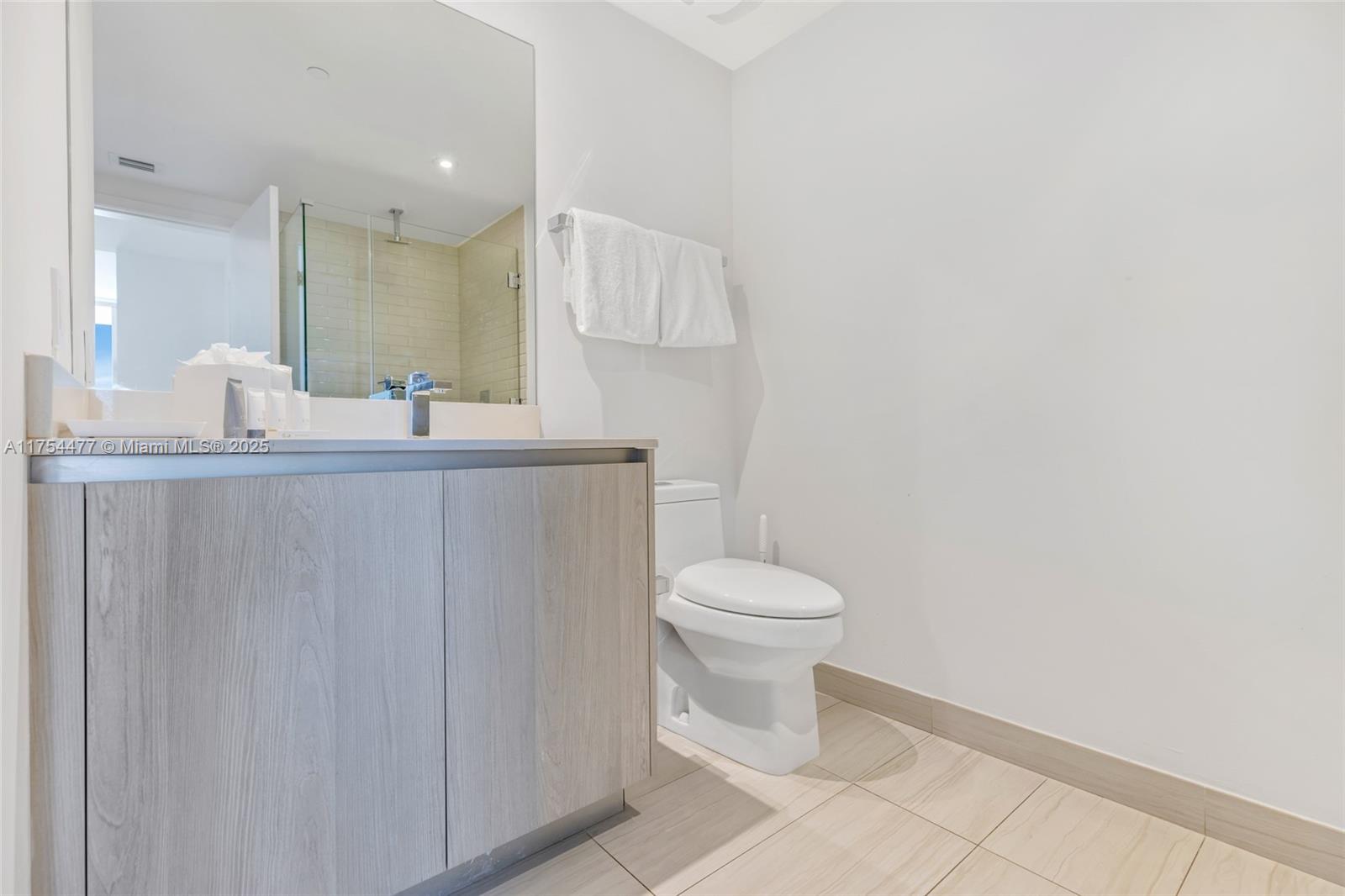 4010 South Ocean Drive, Unit R2505 Hollywood, FL 33019 - Photo 5 of 29 a bathroom with a sink a toilet and mirror