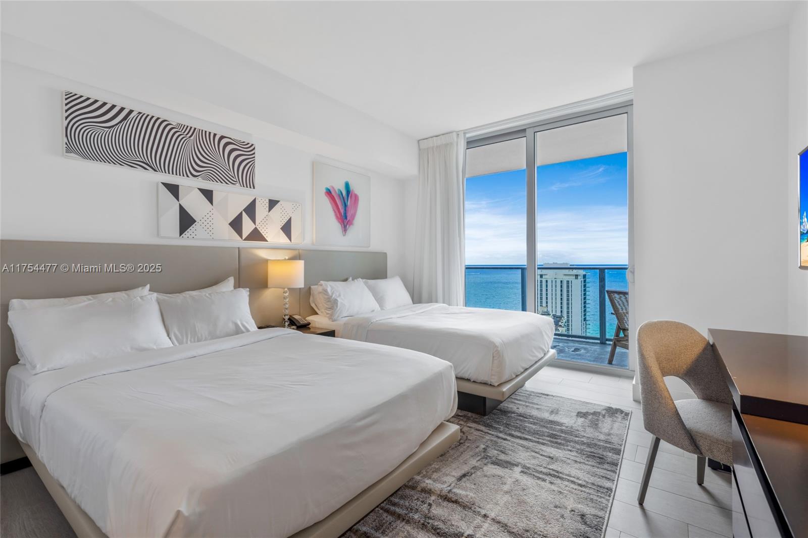 4010 South Ocean Drive, Unit R2505 Hollywood, FL 33019 - Photo 7 of 29 a bedroom with two beds and a table