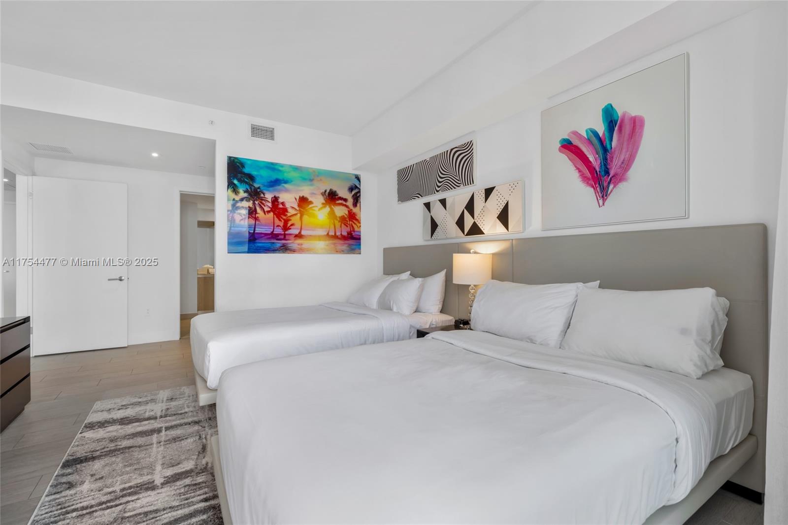 4010 South Ocean Drive, Unit R2505 Hollywood, FL 33019 - Photo 8 of 29 a bedroom with a bed and a painting on the wall