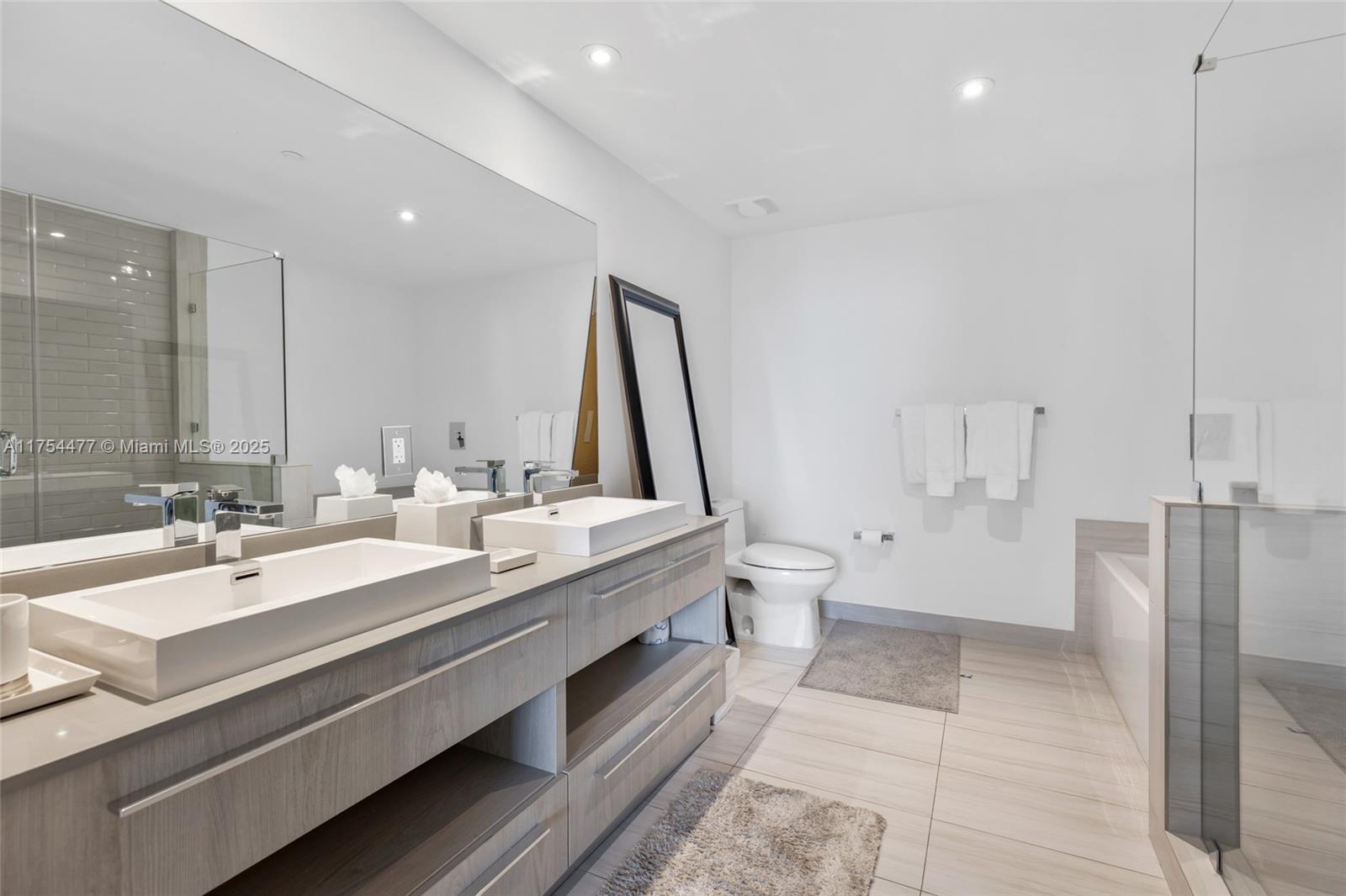 4010 South Ocean Drive, Unit R2505 Hollywood, FL 33019 - Photo 9 of 29 a bathroom with a double vanity sink mirror double and toilet