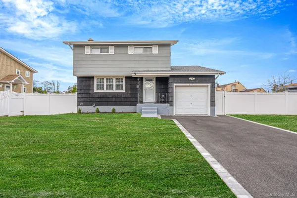a front view of a house with a yard and garage