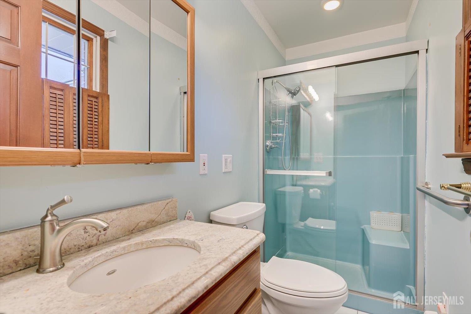 17 Bartha Avenue Edison, NJ 08817 - Photo 16 of 25 a bathroom with a granite countertop sink mirror vanity and toilet