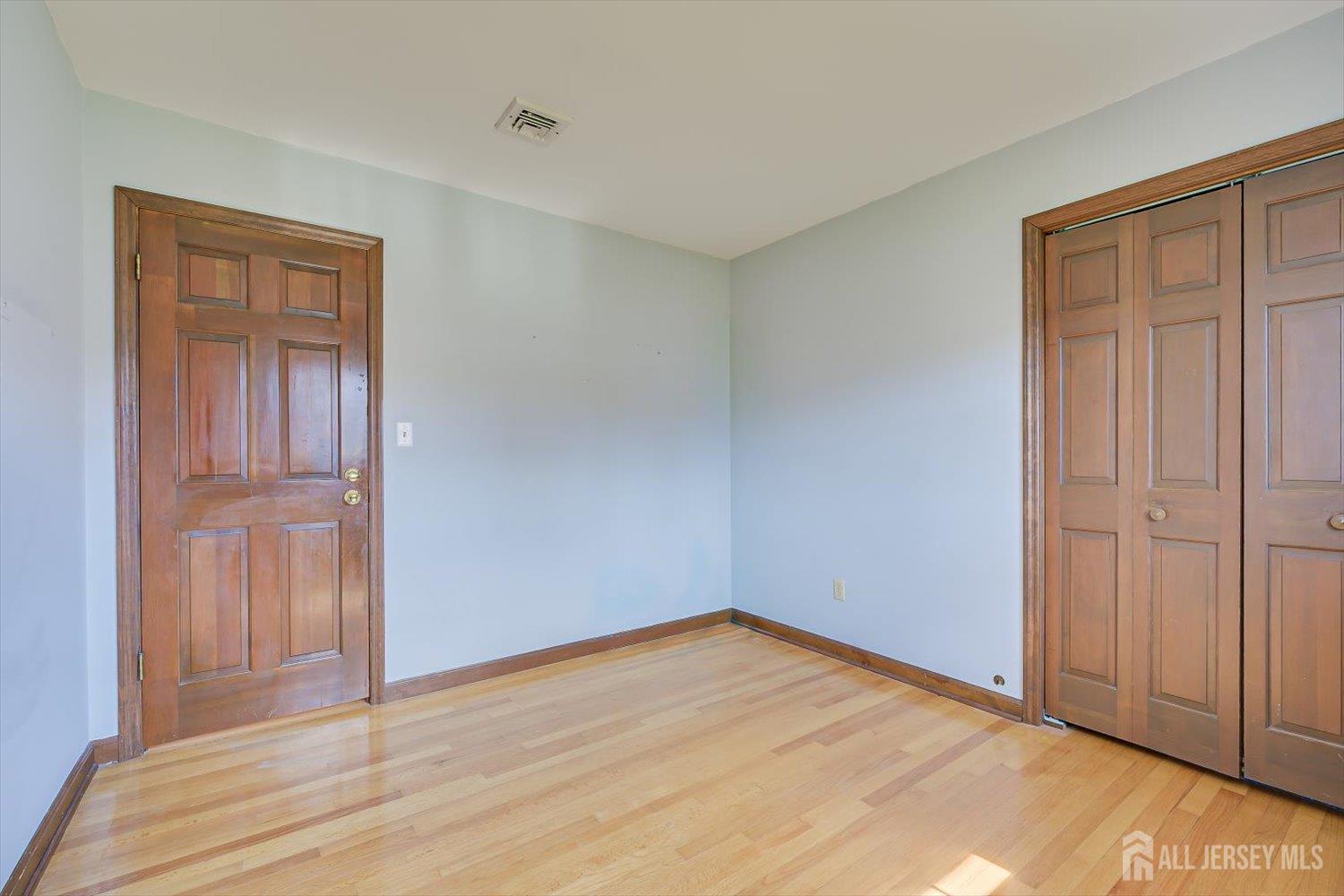 17 Bartha Avenue Edison, NJ 08817 - Photo 19 of 25 a view of empty room with wooden floor and entryway