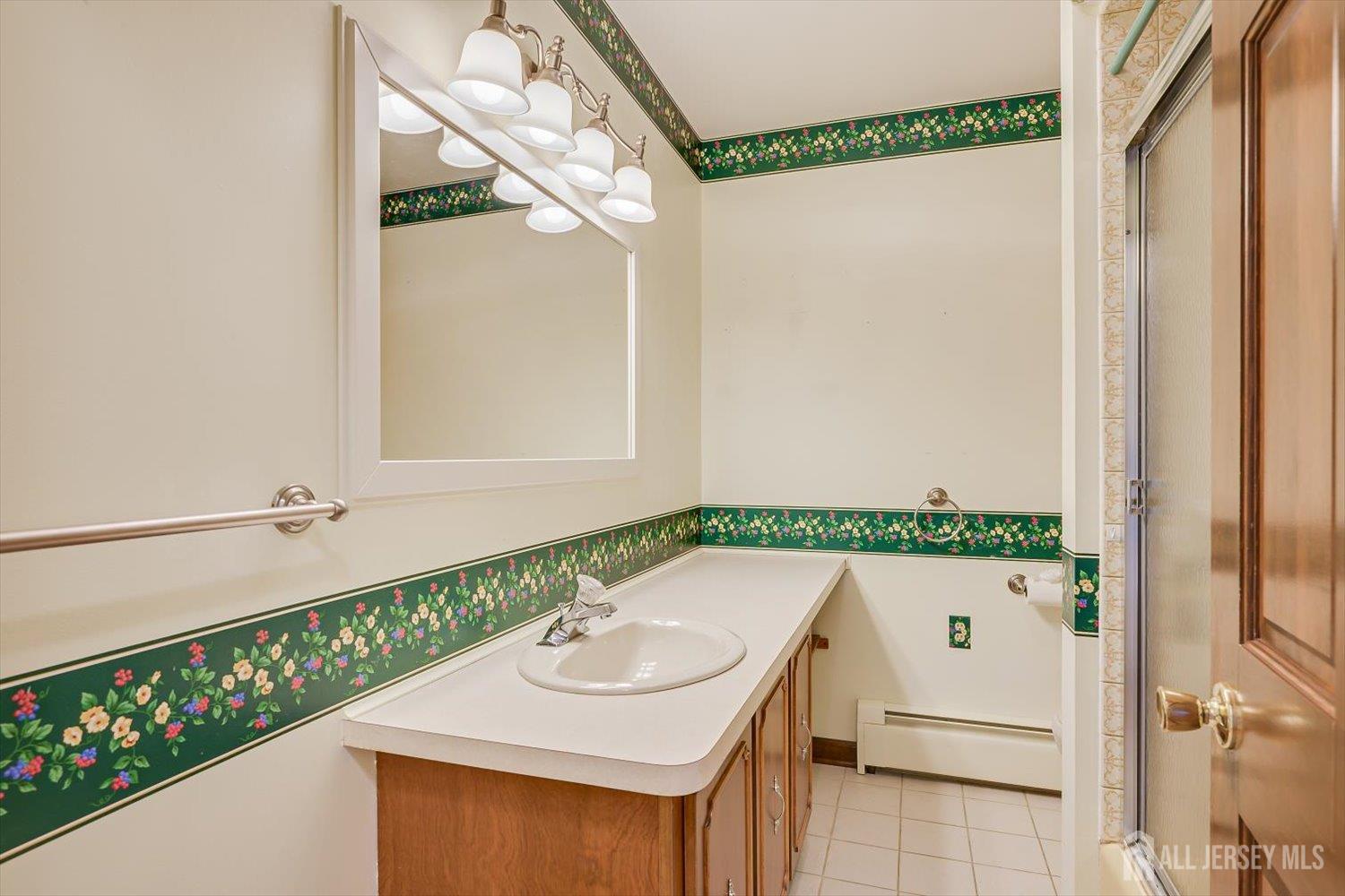 17 Bartha Avenue Edison, NJ 08817 - Photo 20 of 25 a bathroom with a sink and a mirror