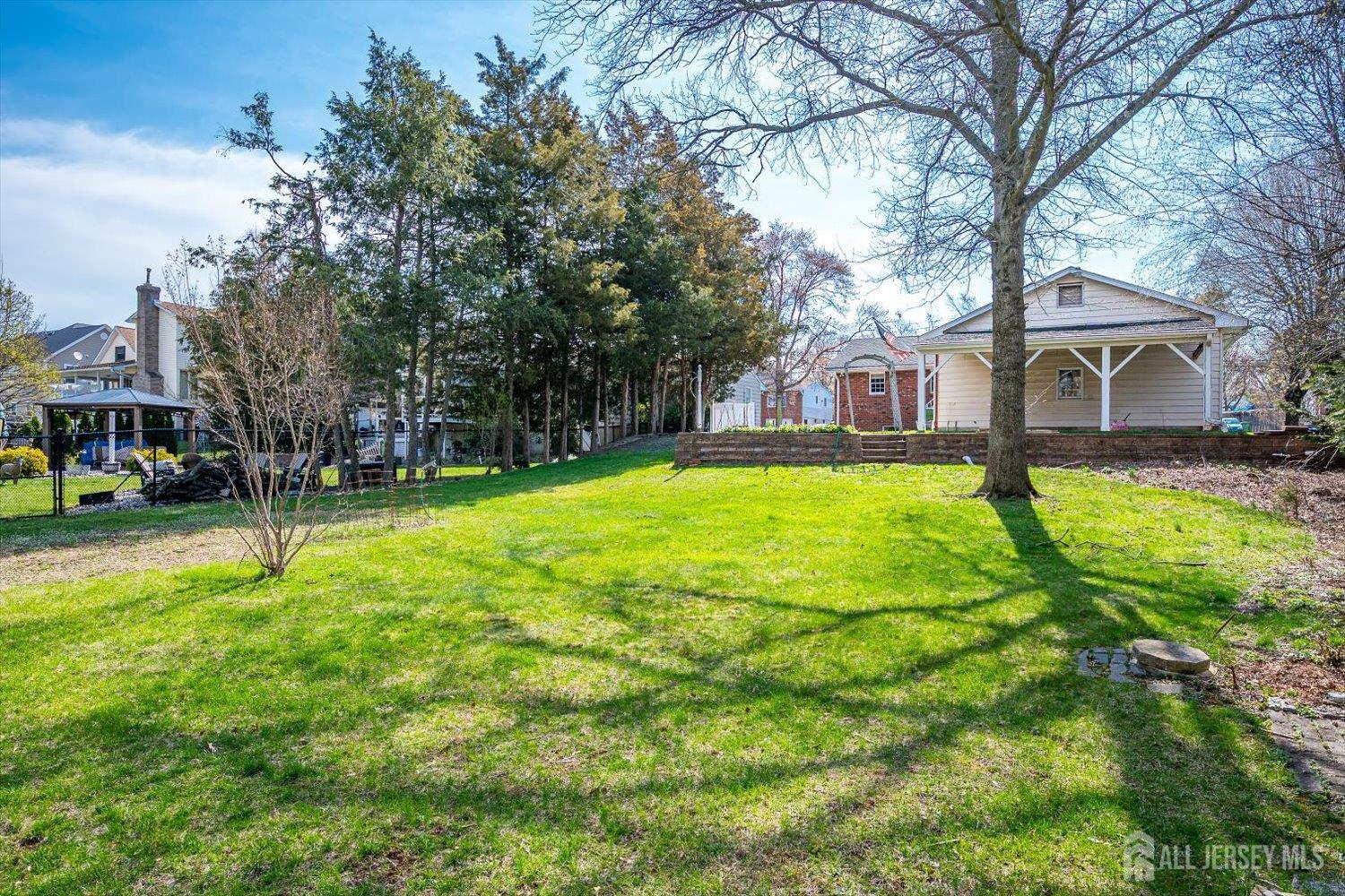 17 Bartha Avenue Edison, NJ 08817 - Photo 23 of 25 a view of a house with a big yard and large trees