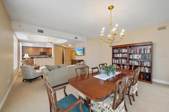 a view of a dining room with furniture a rug and wooden floor