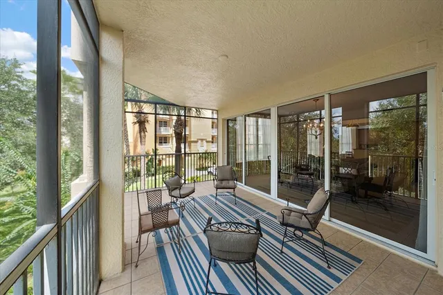 a living room with furniture and a floor to ceiling window