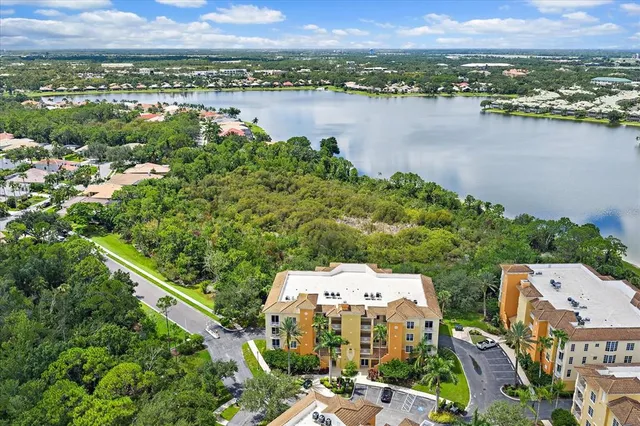 an aerial view of a house with a big yard and large trees