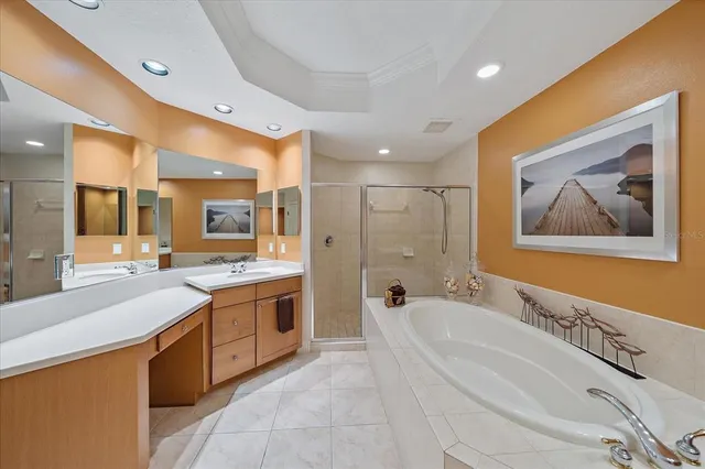 a large bathroom with a tub a sink and mirror