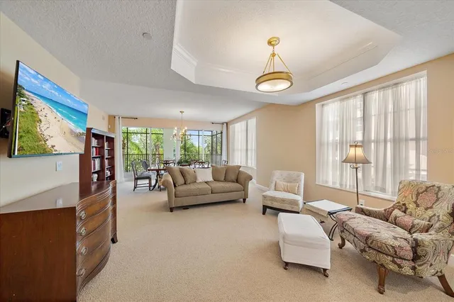 a living room with furniture a fireplace and a large window