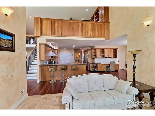 a living room with furniture a rug and a painting on the wall
