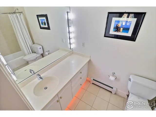 a bathroom with a sink mirror and toilet