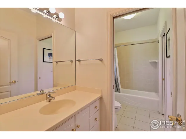 a bathroom with a granite countertop sink mirror and shower