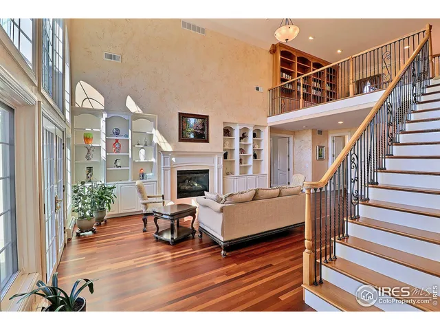 a view of a livingroom with furniture staircase and a fireplace