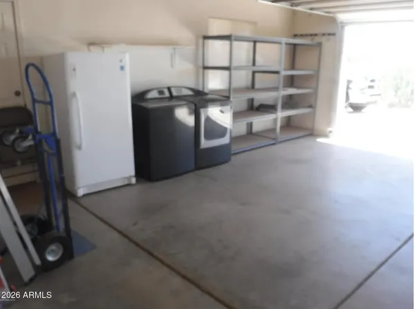 a view of a storage & utility room with two washing machine