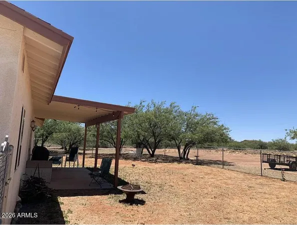 a view of a backyard with a patio