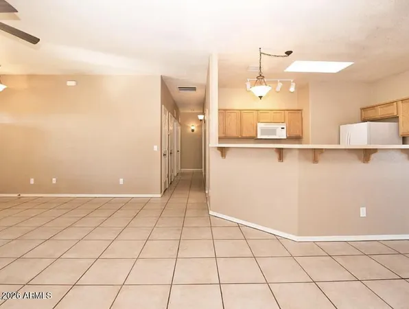 a view of a kitchen with wooden floor and a cabinet