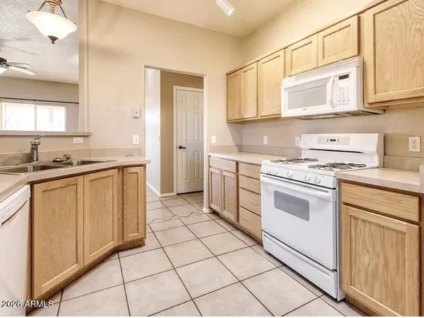 a kitchen with a stove sink and cabinets