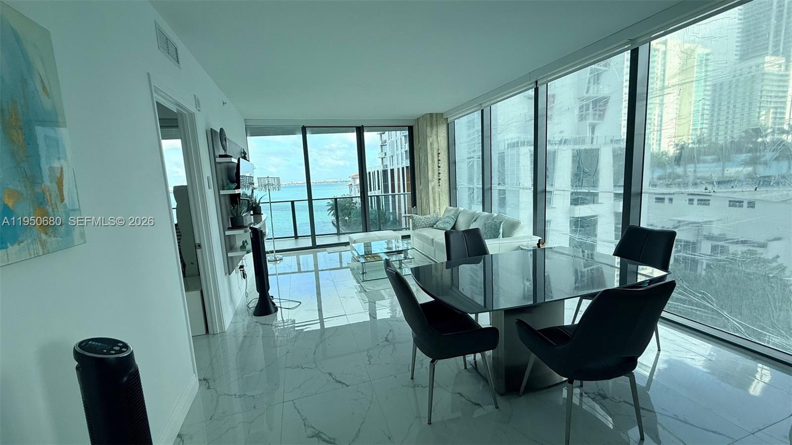 460 Northeast 28th Street, Unit 608 Miami, FL 33137 - Photo 2 of 10 a view of a dining room with furniture window and outside view