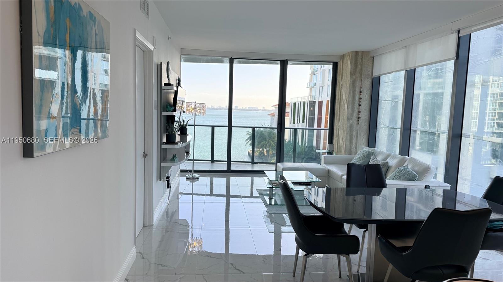 460 Northeast 28th Street, Unit 608 Miami, FL 33137 - Photo 9 of 10 a dining room with furniture and large windows