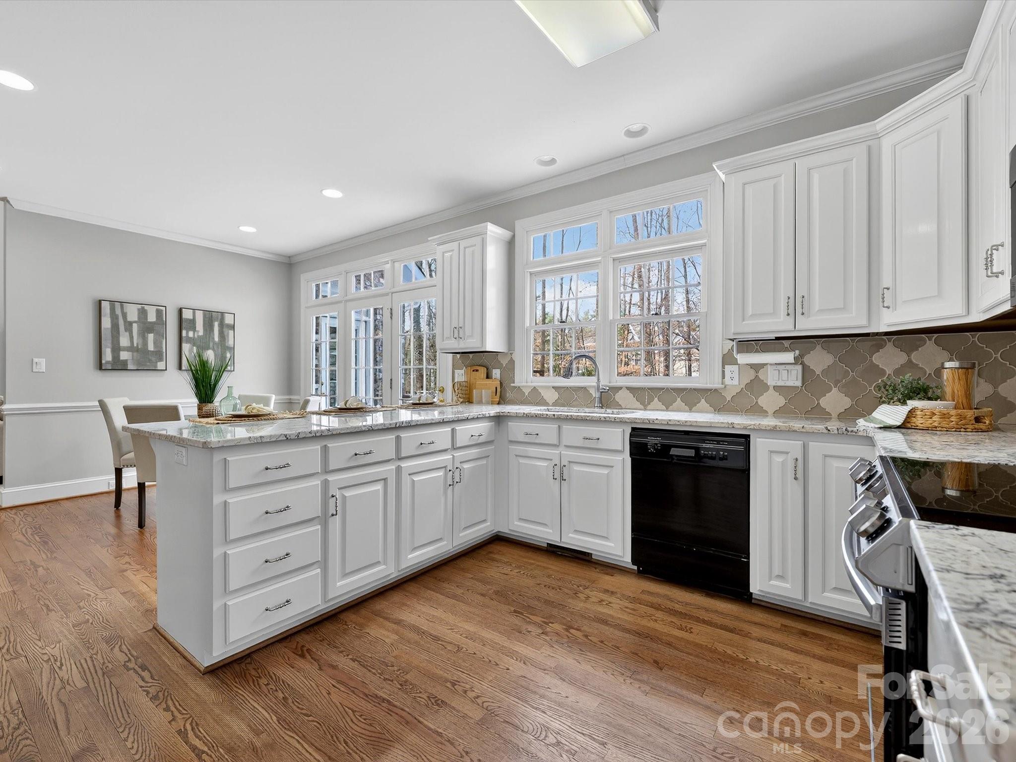 13417 Scanlan Way Davidson, NC 28036 - Photo 12 of 48 a kitchen with granite countertop a sink cabinets stainless steel appliances and a window