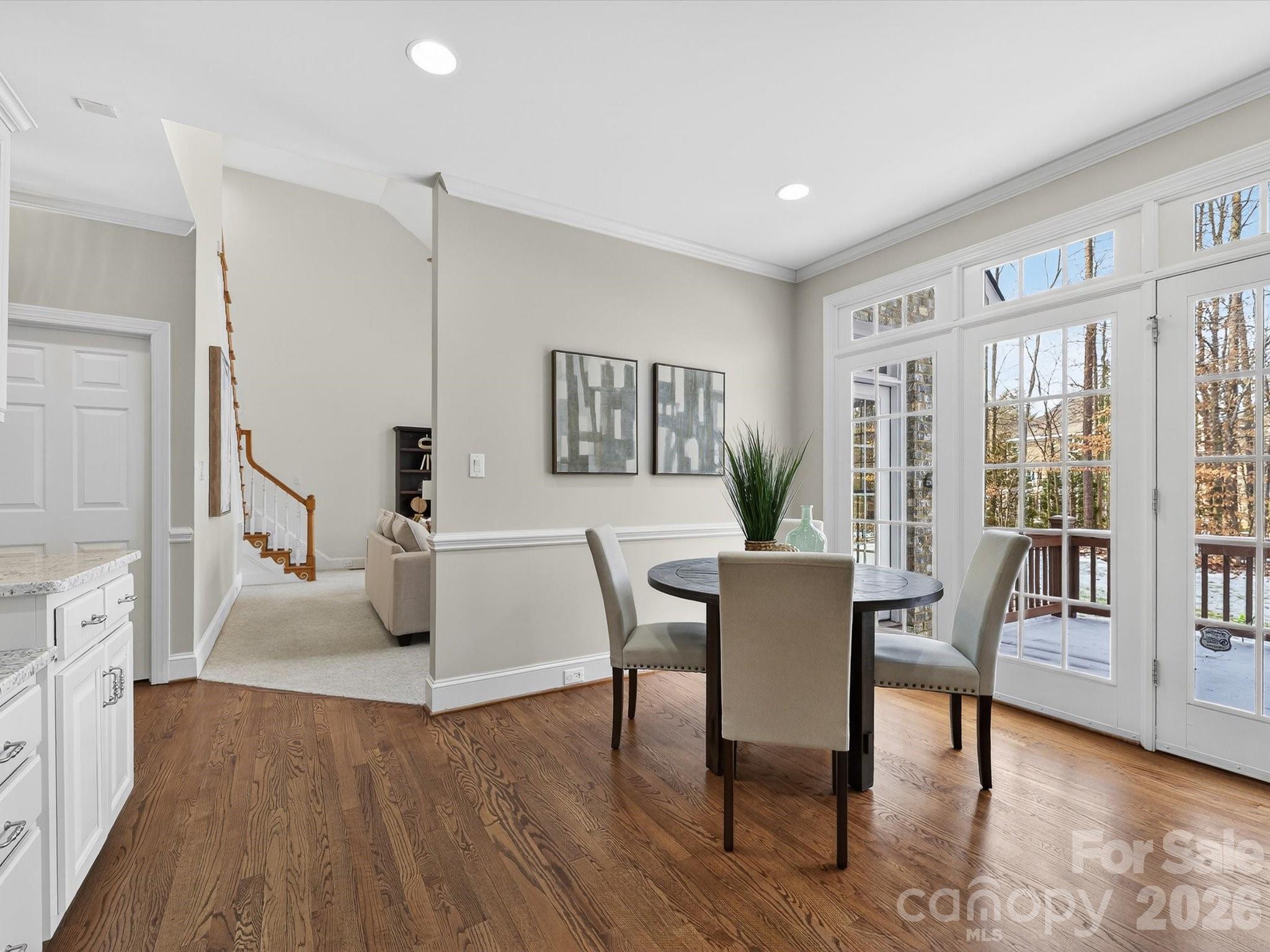 13417 Scanlan Way Davidson, NC 28036 - Photo 15 of 48 a view of a livingroom with furniture and a dining table with wooden floor