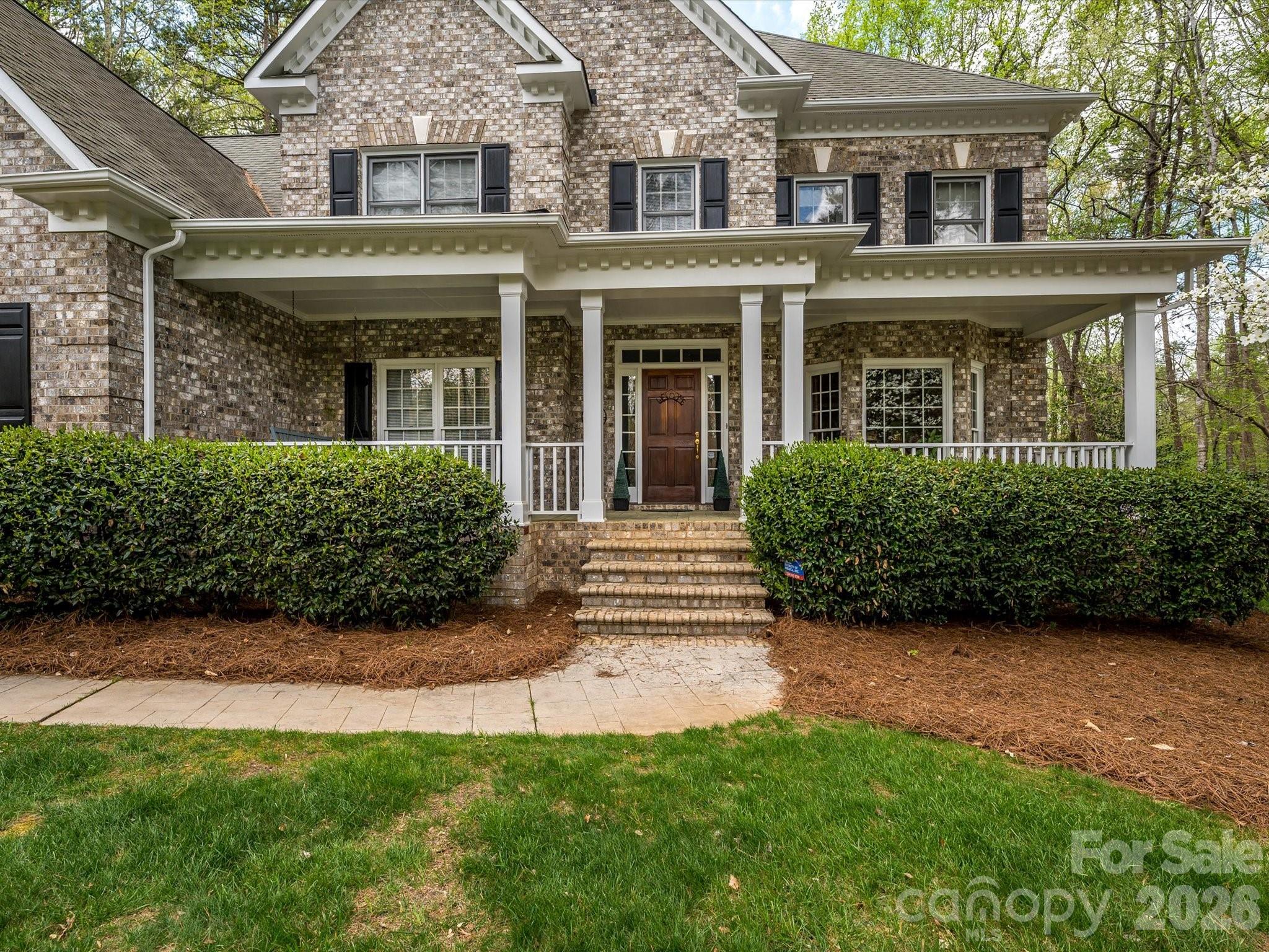 13417 Scanlan Way Davidson, NC 28036 - Photo 2 of 48 front view of a brick house with a yard