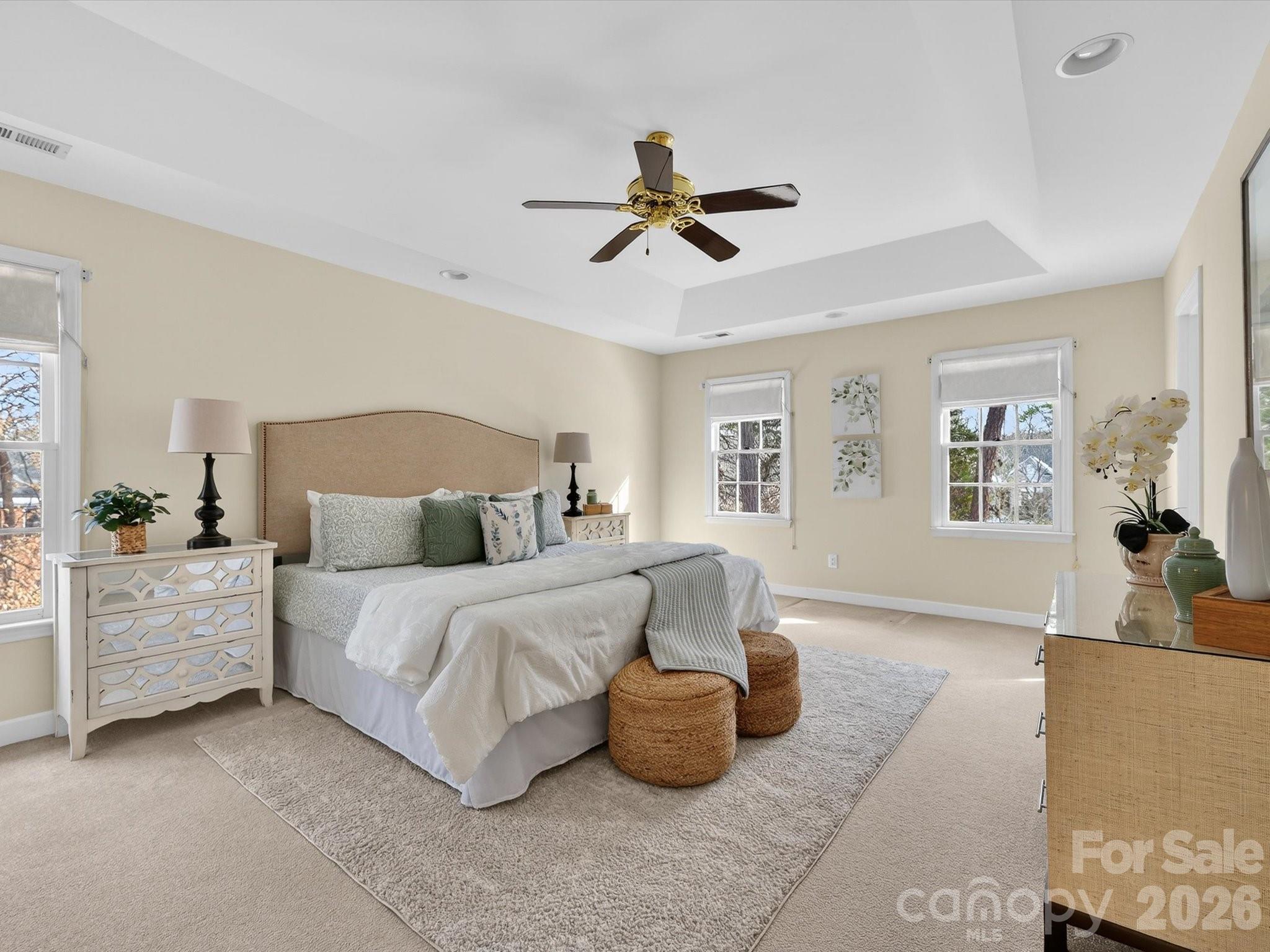 13417 Scanlan Way Davidson, NC 28036 - Photo 24 of 48 a spacious bedroom with a bed and a couch