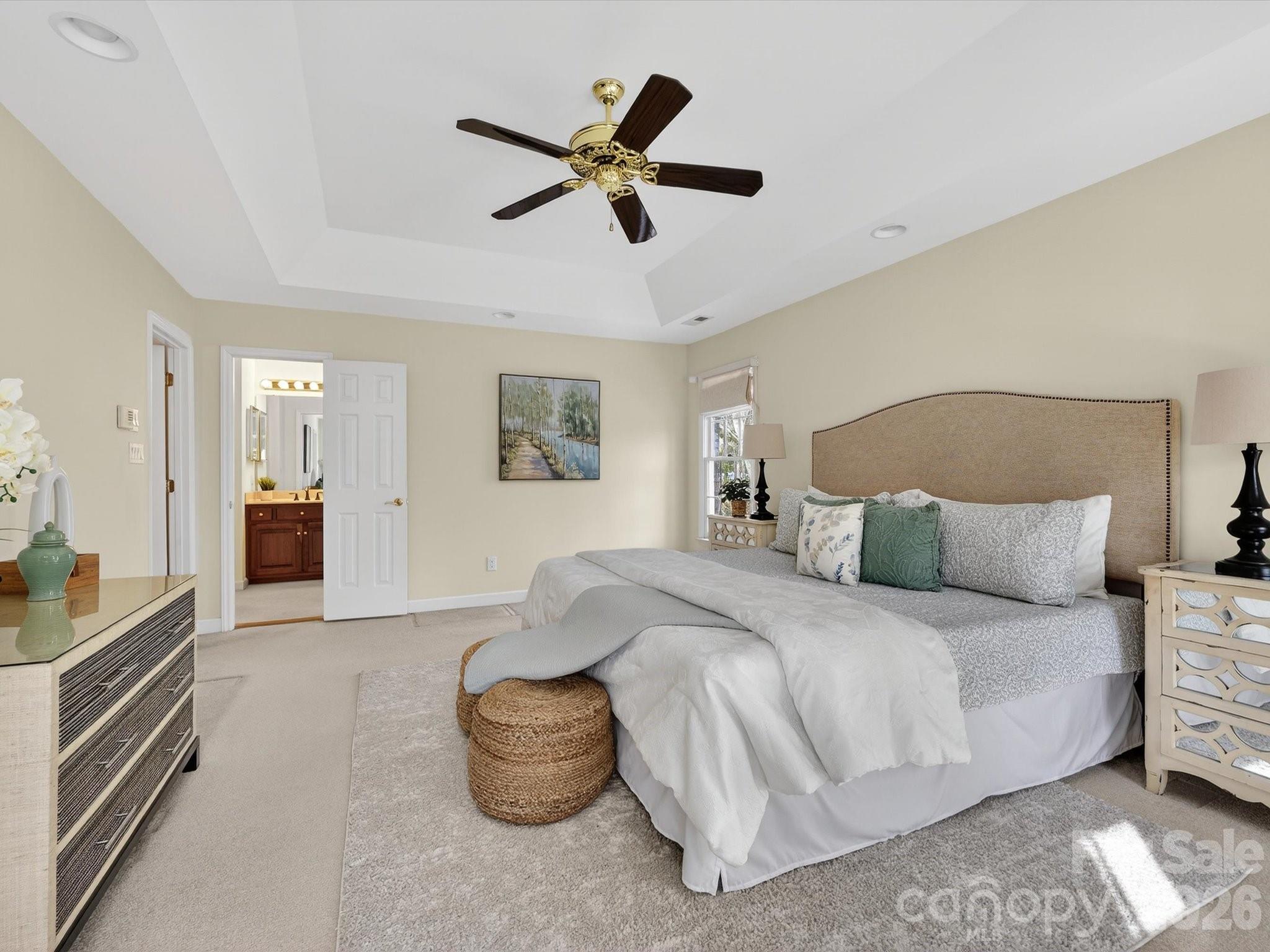 13417 Scanlan Way Davidson, NC 28036 - Photo 25 of 48 a spacious bedroom with a bed and ceiling fan