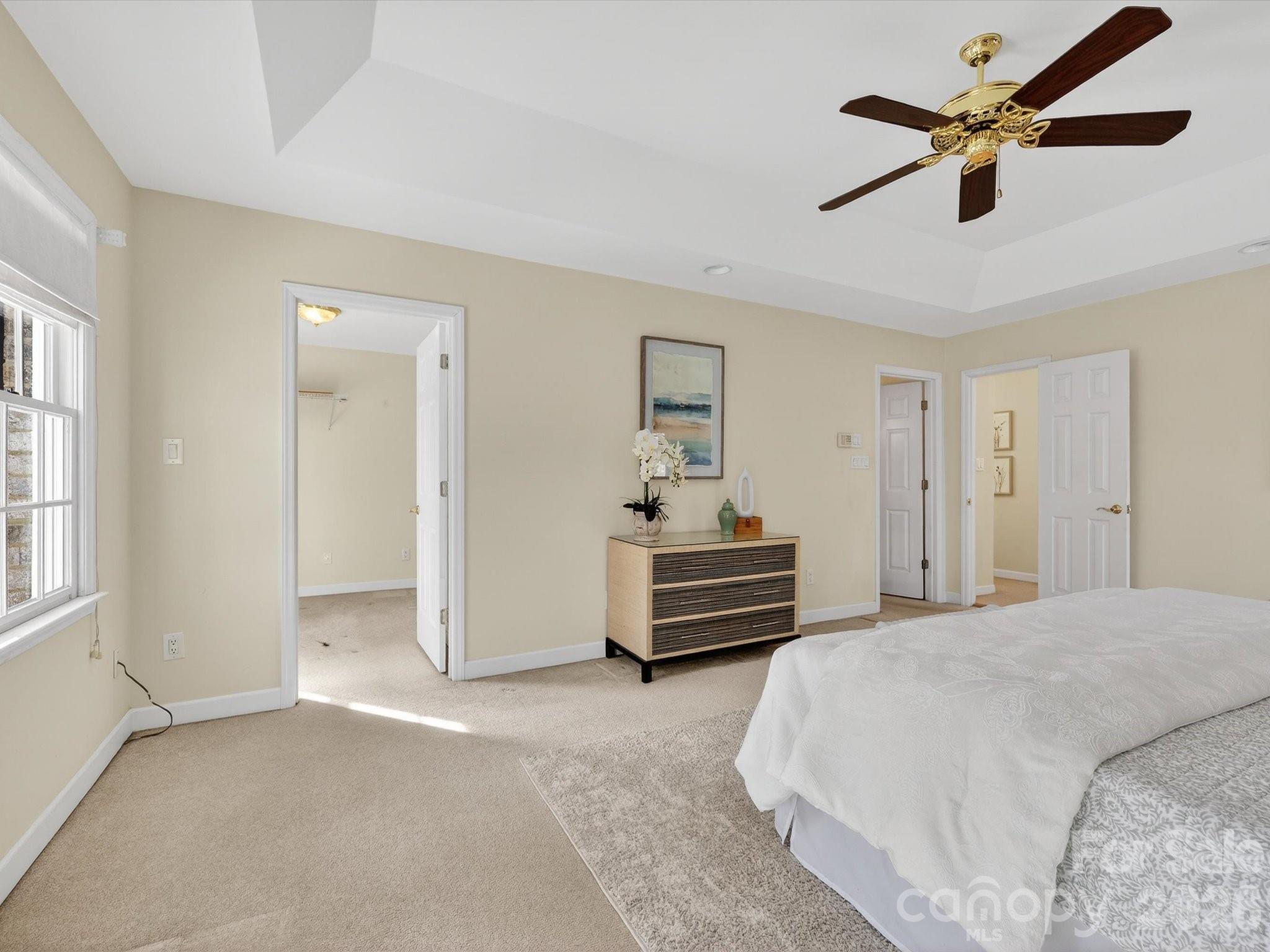 13417 Scanlan Way Davidson, NC 28036 - Photo 26 of 48 a bedroom with a bed and a chandelier