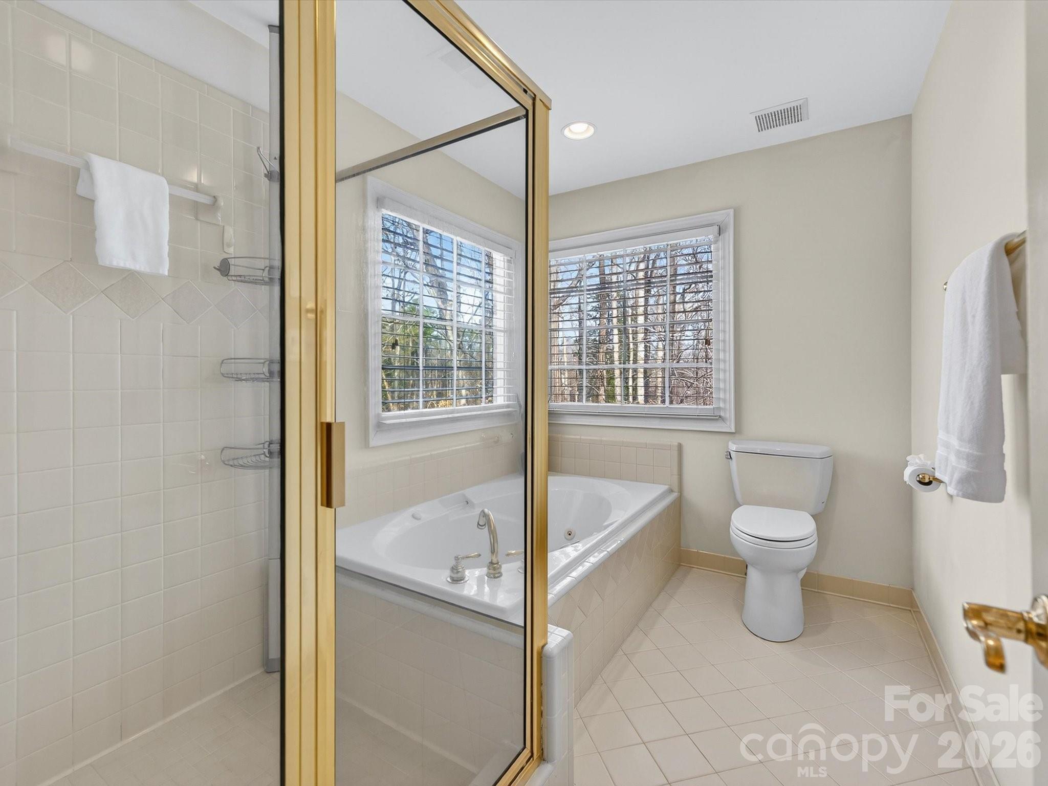 13417 Scanlan Way Davidson, NC 28036 - Photo 29 of 48 a bathroom with a tub and toilet