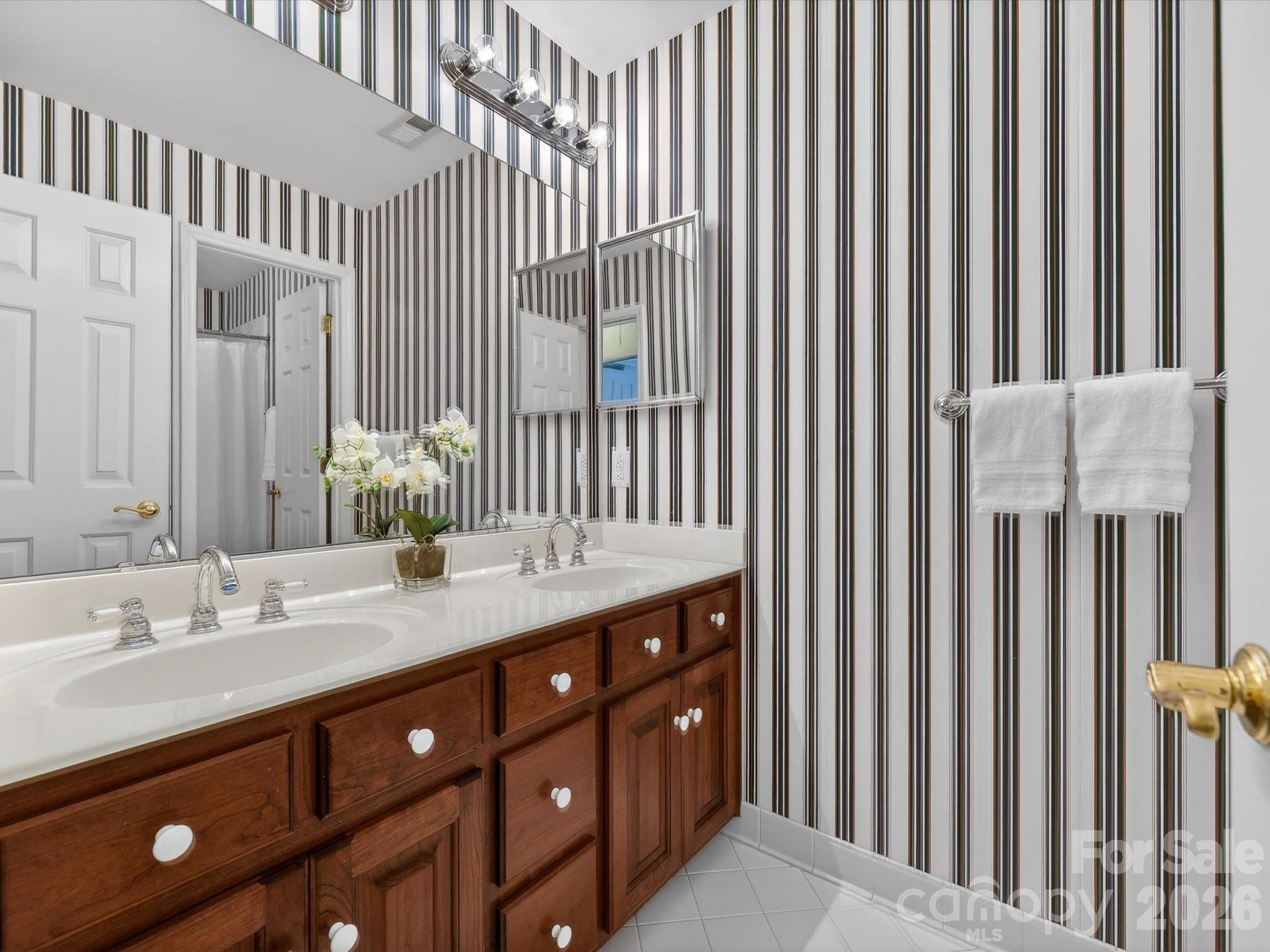 13417 Scanlan Way Davidson, NC 28036 - Photo 35 of 48 a bathroom with a double vanity sink and a mirror