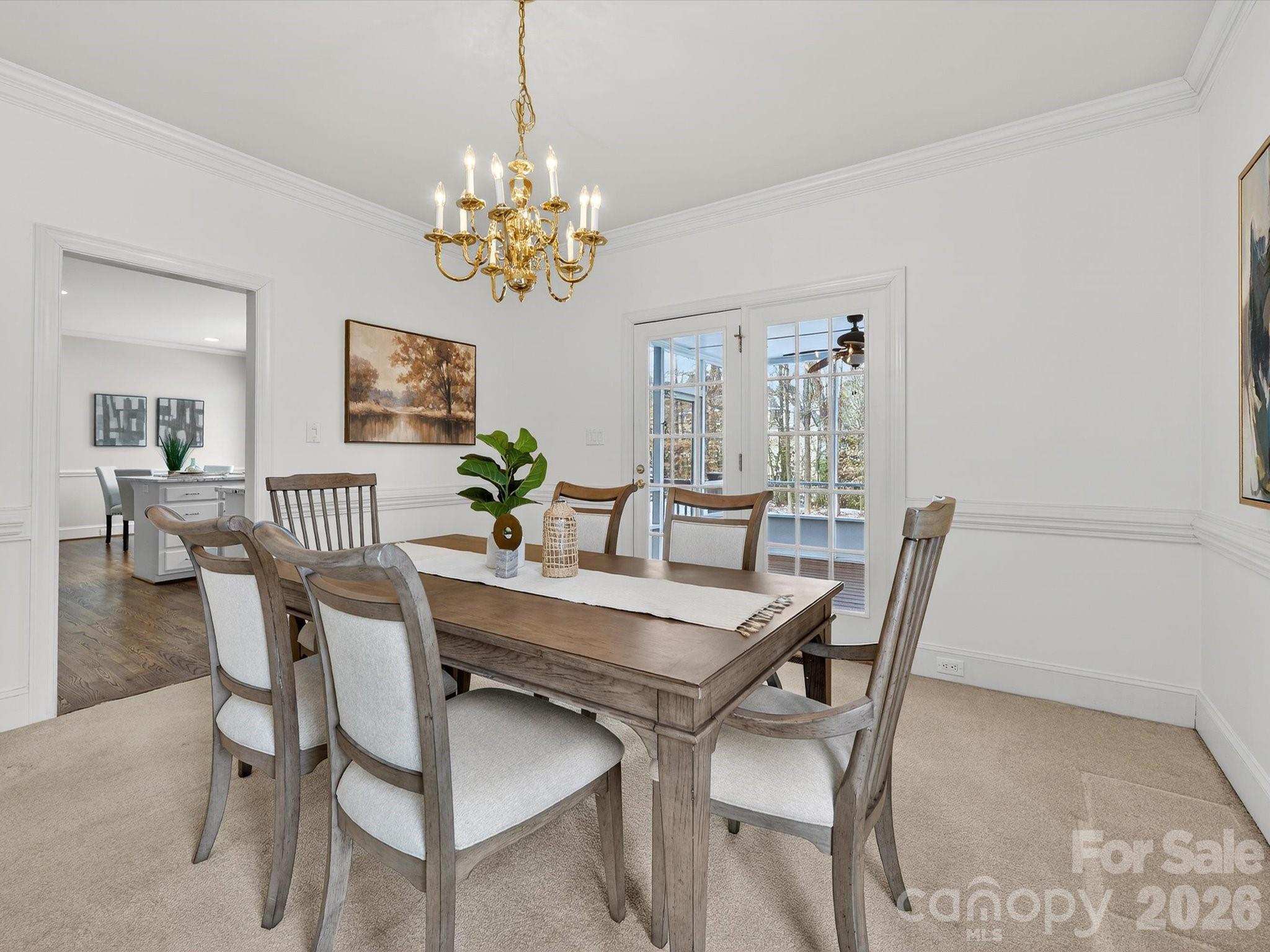13417 Scanlan Way Davidson, NC 28036 - Photo 8 of 48 a view of a dining room with furniture a chandelier and wooden floor