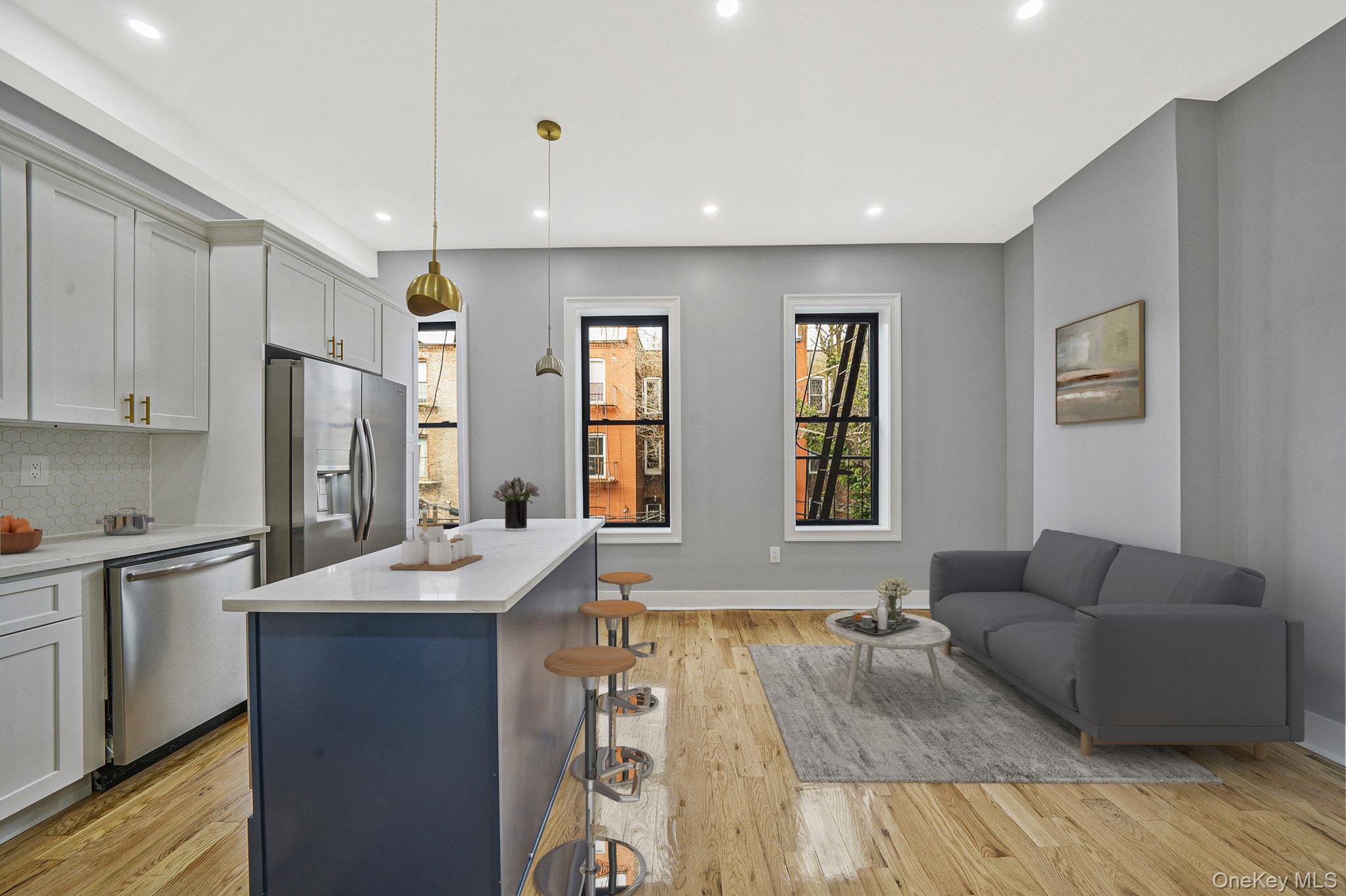 581 Decatur Street Brooklyn, NY 11233 - Photo 6 of 12 a living room with stainless steel appliances kitchen island granite countertop furniture and a wooden floor