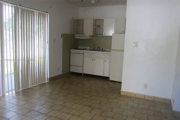 a view of kitchen with granite countertop window