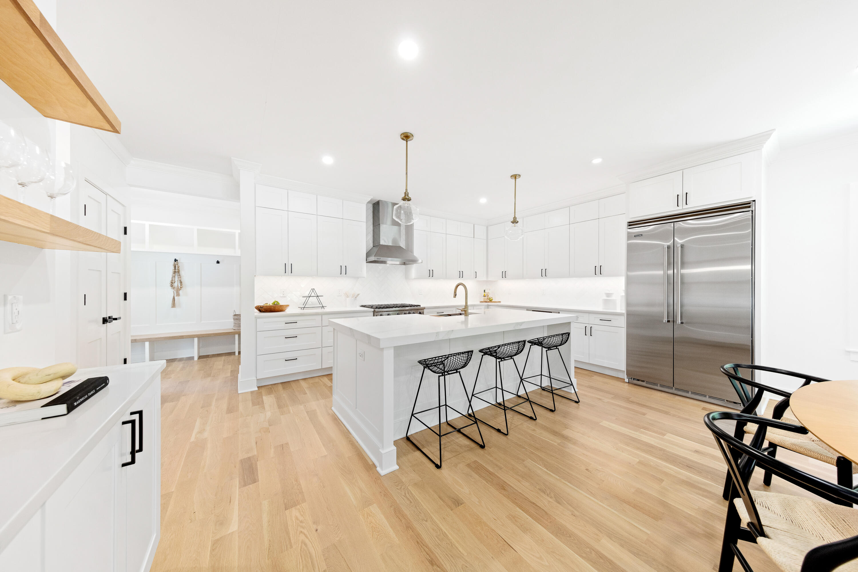 14 Edgewood Road Darien, CT 06820 - Photo 11 of 38 a kitchen with stainless steel appliances kitchen island hardwood floor sink stove and white cabinets