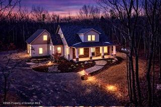 a view of a house with a yard fire pit and outdoor seating