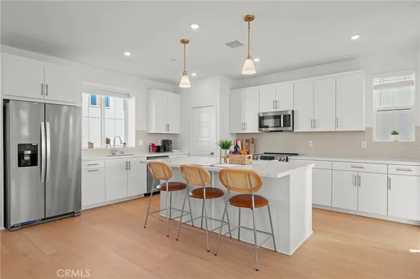 a living room with furniture and kitchen view