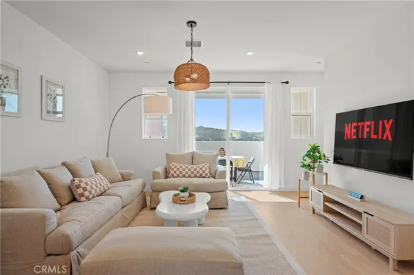 a large kitchen with kitchen island a sink table and chairs