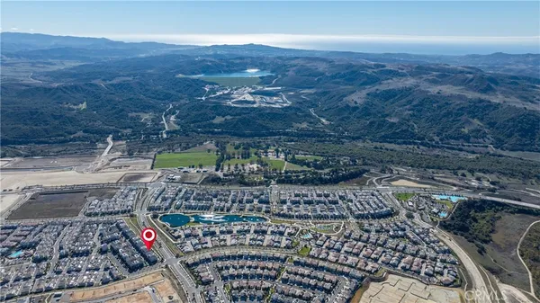 an aerial view of a swimming pool patio and mountain view in back